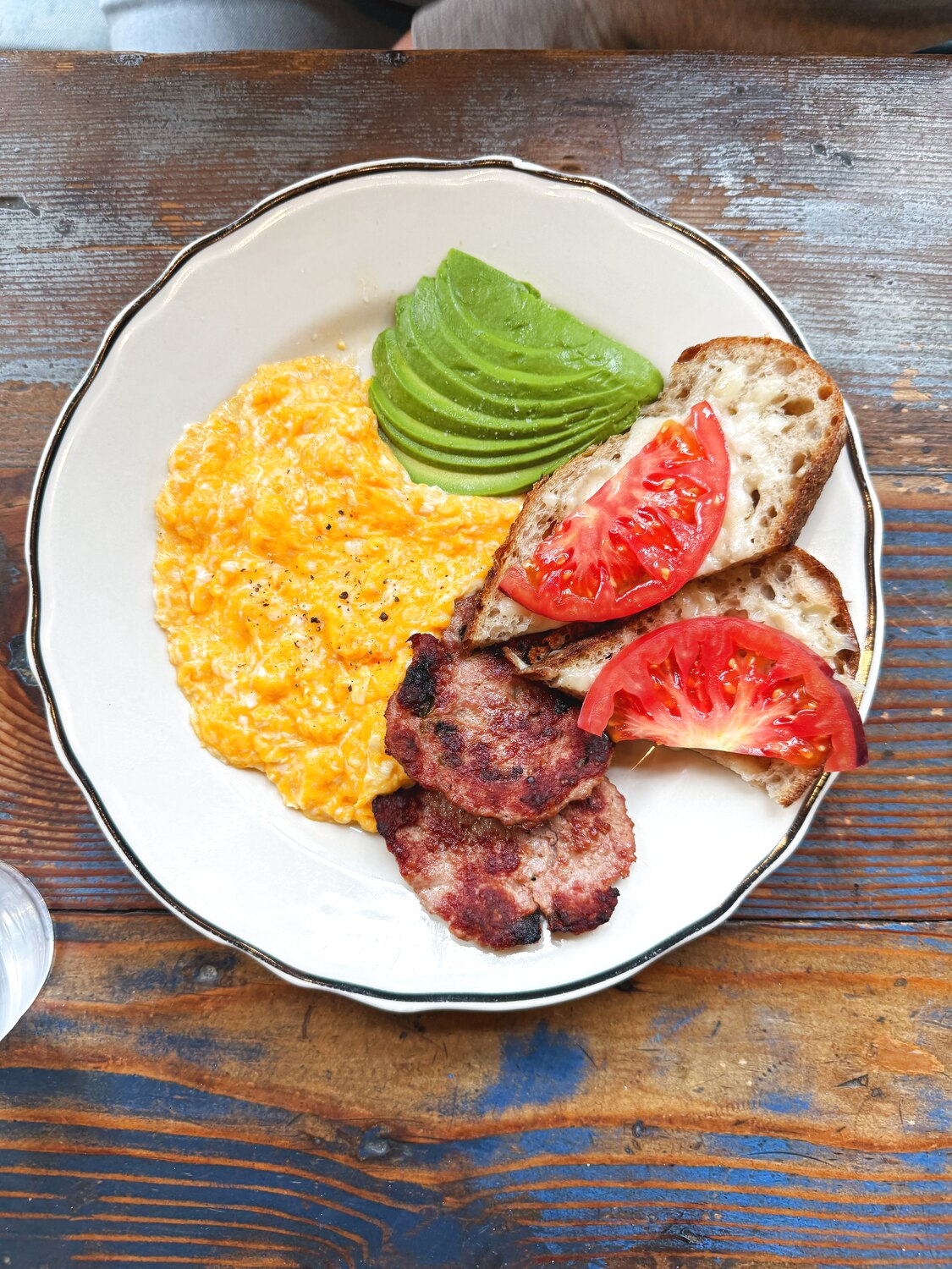 A plate of eggs, avocado and bacon
